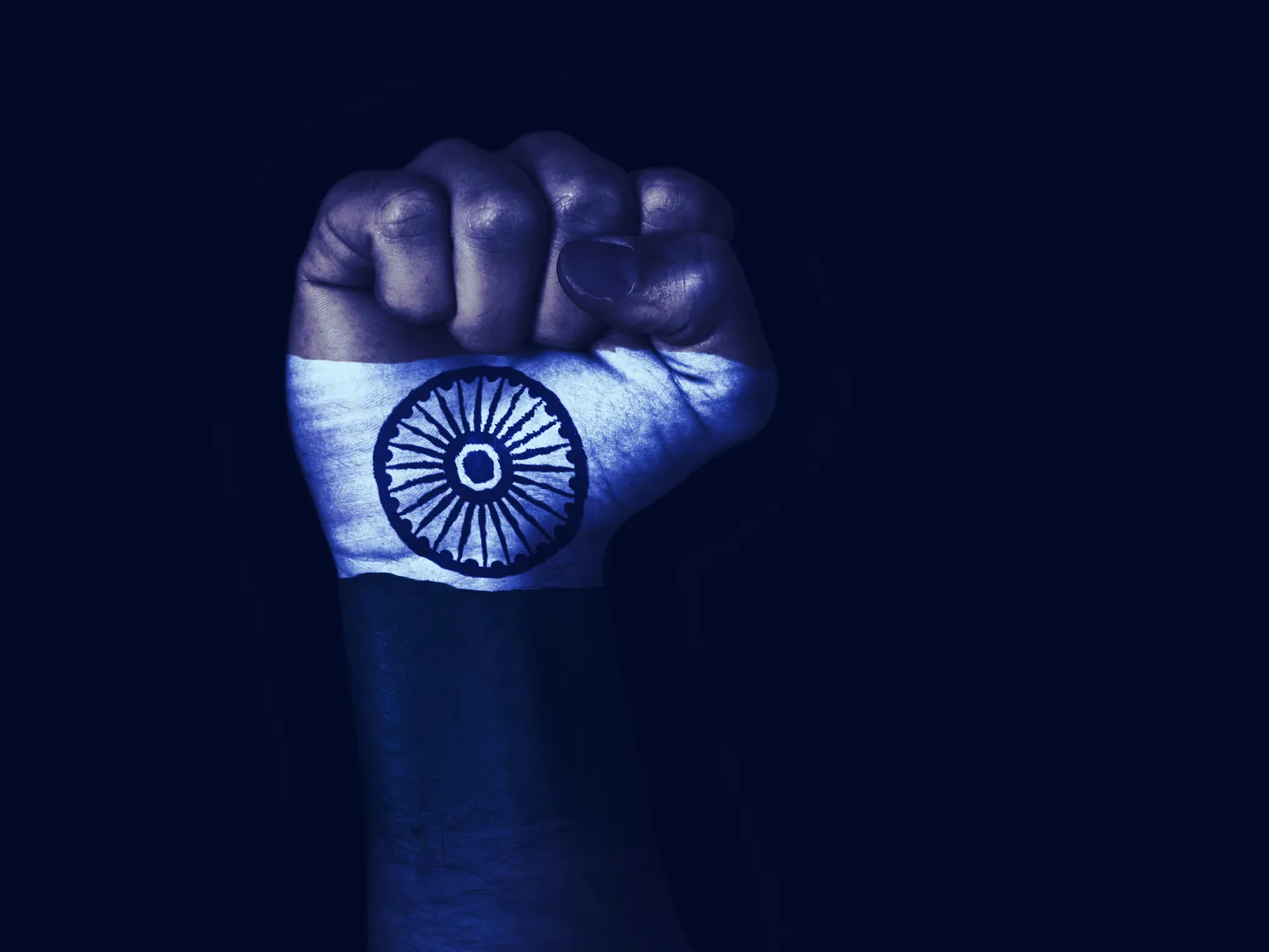 Flag of India painted on raised fist. Image: Shutterstock