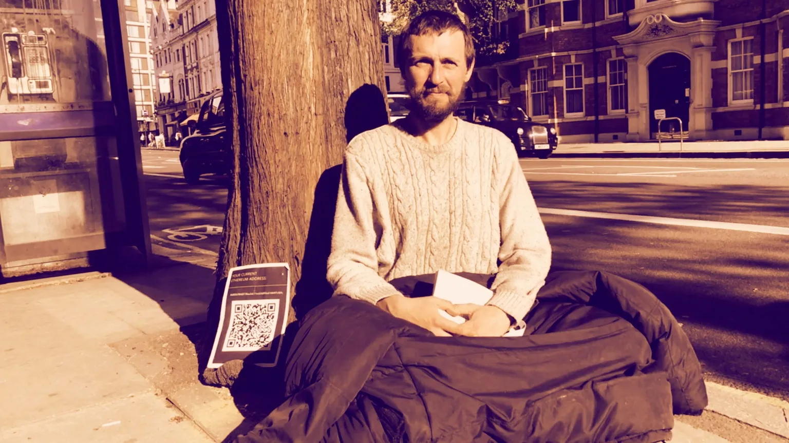 Begging for ether outside Blockchain Expo in London, April, 2018. IMAGE SOURCE: Adriana Hamacher