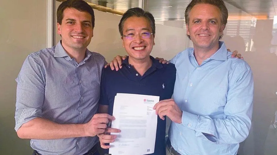 Sygnum cofounders Mathias Imbach, Gerald Goh and Manuel Strieger with the letter containing approval from FINMA. SOURCE: Sygnum