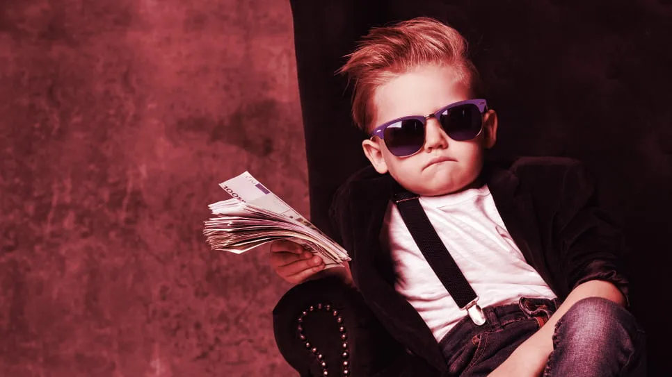 A kid holding a wad of cash. Image: Shutterstock.