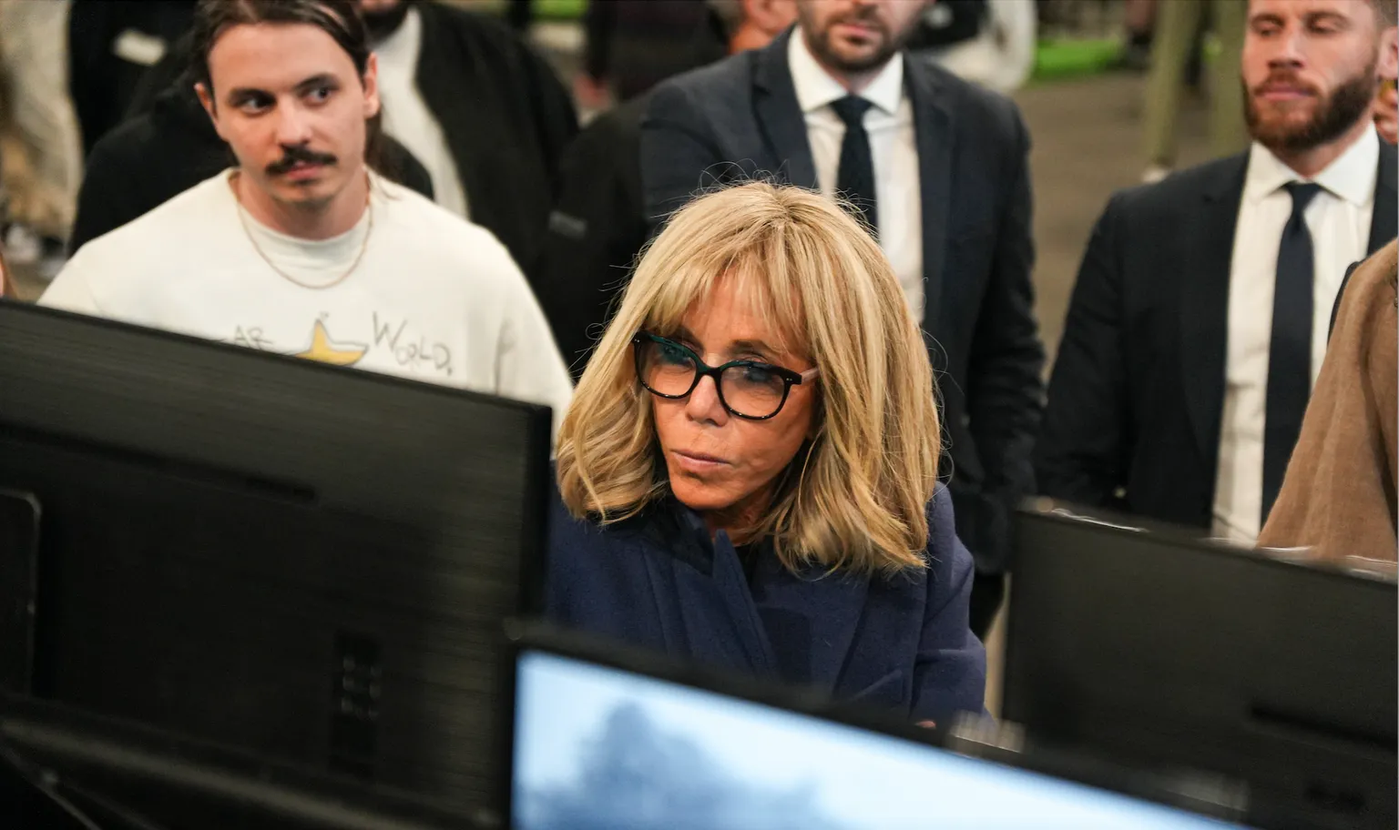 Brigitte Macron checks out a booth at NFT Paris on February 24, 2023 as NFT Paris Co-founder Alexandre Tsydenkov looks on. (Image: LA FRENCH IMAGERIE)