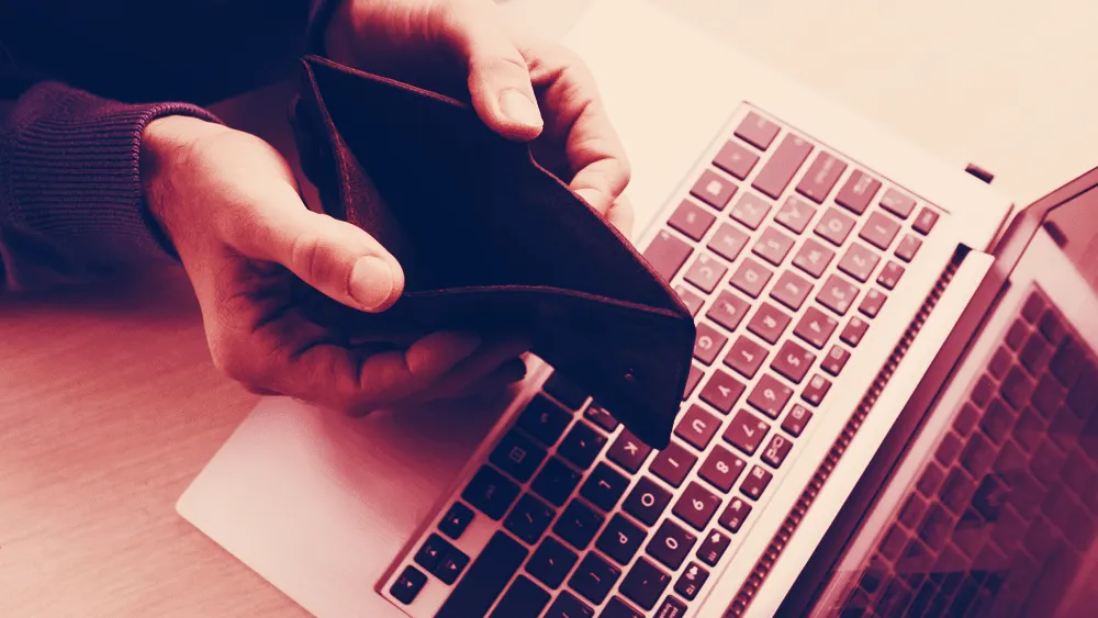 Man holding an empty wallet. Image: Shutterstock