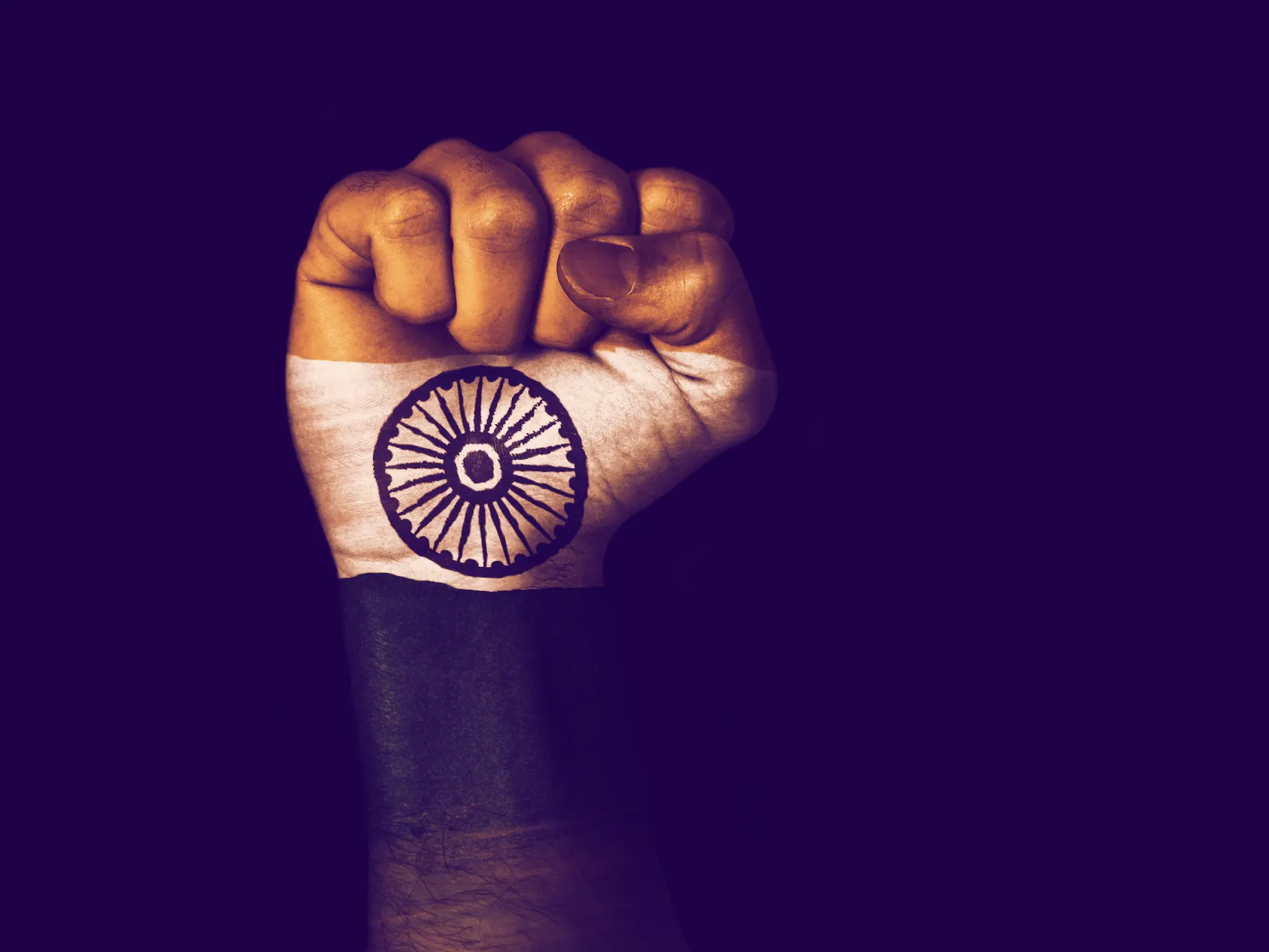 Flag of India painted on raised fist. Image: Shutterstock