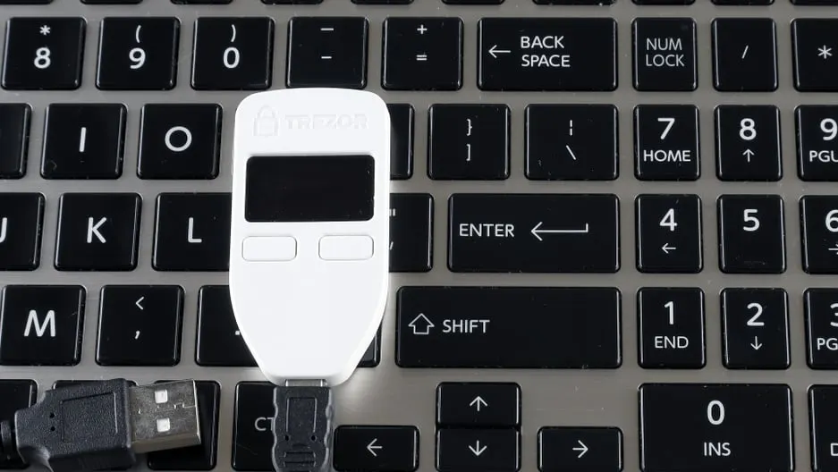 Trezor hardware wallet on a keyboard