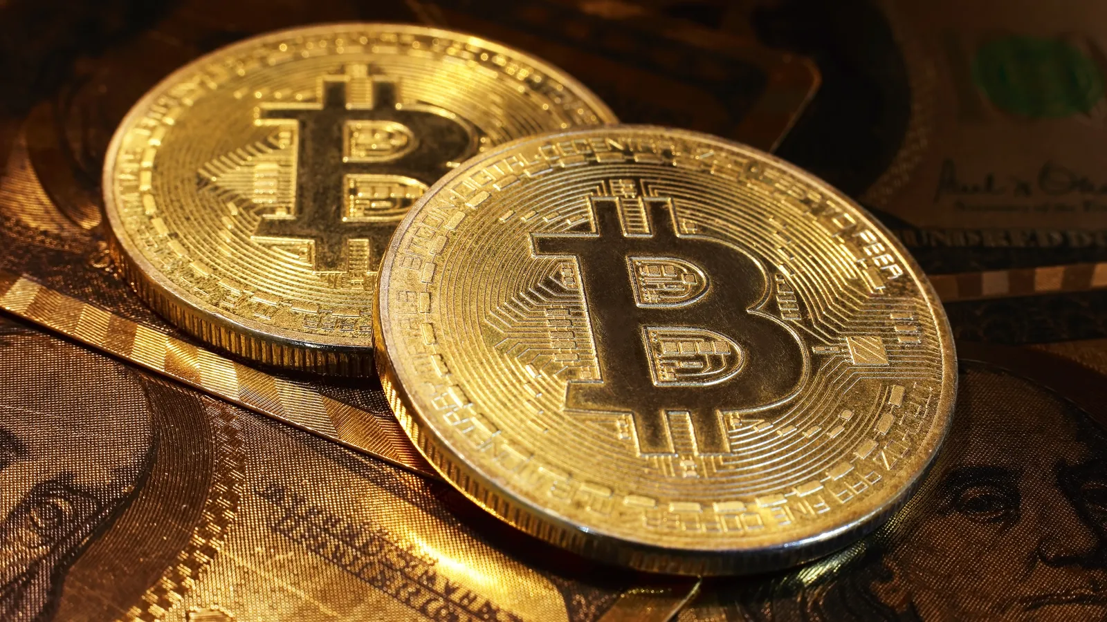 Golden bitcoin with dollar background