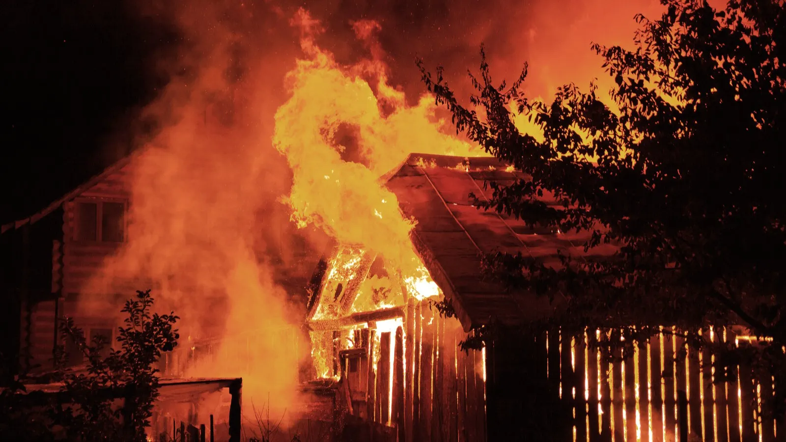 Wooden house or barn burning on fire at night. Image: Shutterstock