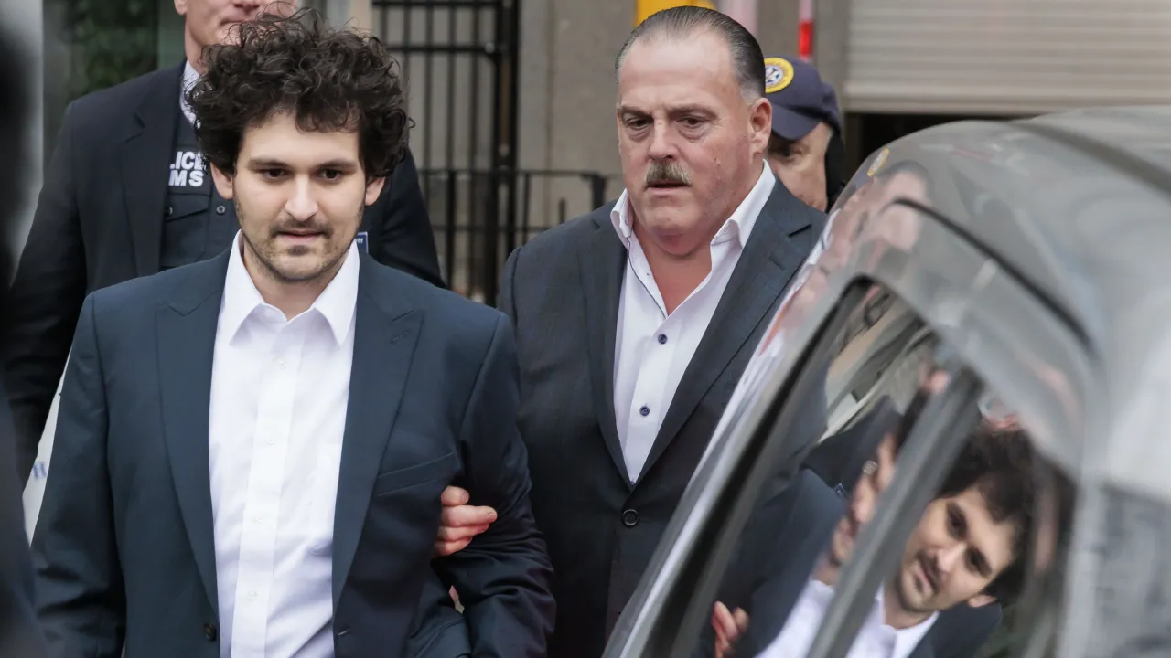 Cryptocurrency entrepreneur Sam Bankman-Fried (L) is lead out of an U.S. Federal Courthouse after being released on bail following an arraignment in New York, New York, USA, 22 December 2022. Bankman-Fried, who was extradited to the U.S. from the Bahamas yesterday, is facing federal charges that he used money from investors illegally for personal gain.