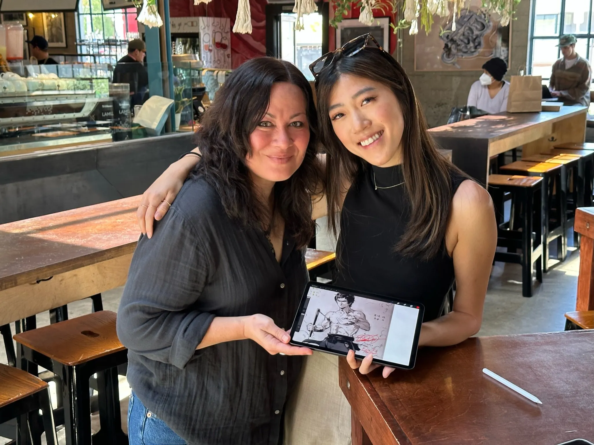 Shannon Lee (izquierda) y Emily "pplpleasr" Yang con la obra de arte de NFT. Imagen: Shibuya