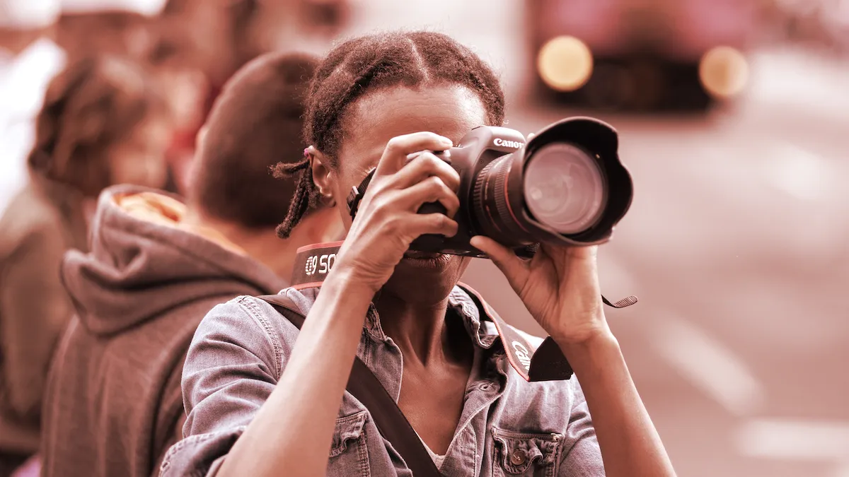 A photographer with a Canon camera. Image: Shutterstock