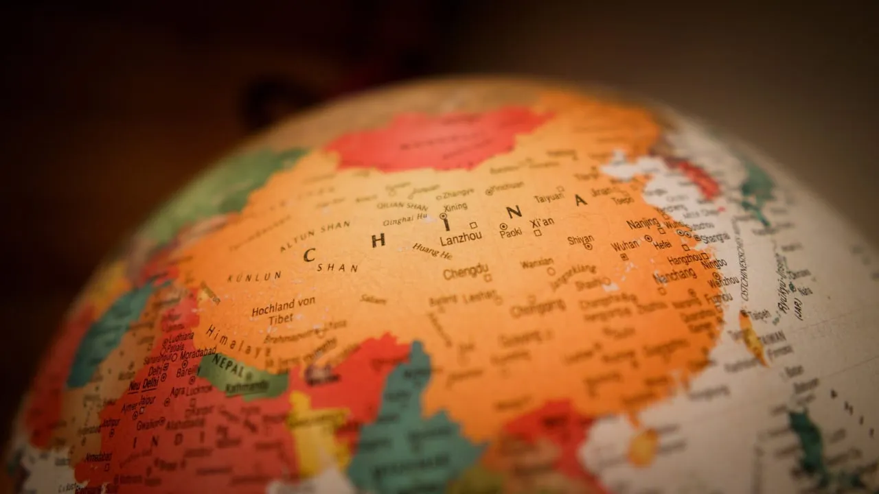China on a globe. Photo: Christian Lue on Unsplash