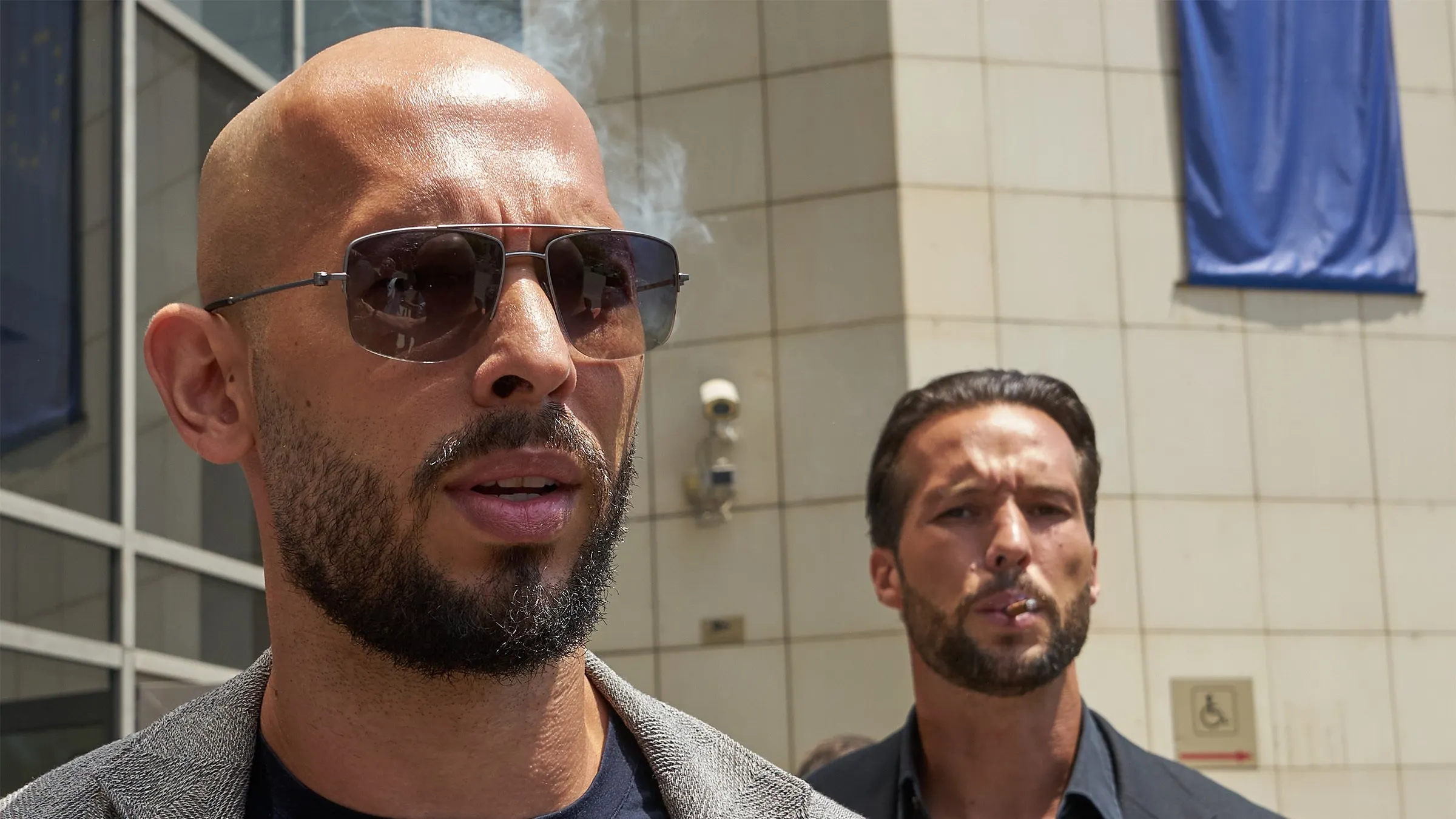 Andrew Tate and his brother Tristan Tate leave a Romanian courthouse in June 2023. Image: LCV/Shutterstock