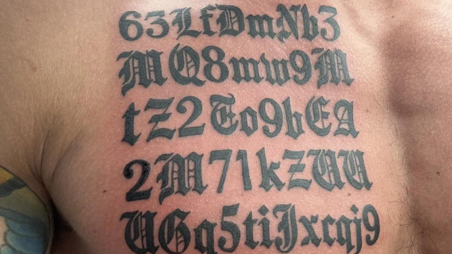 Gigachad contract address tattooed on chest, spelt wrong