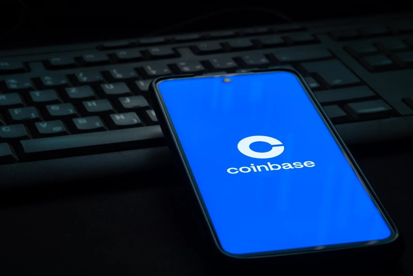 Coinbase logo on smartphone screen laying on computer keyboard. Image: Shutterstock