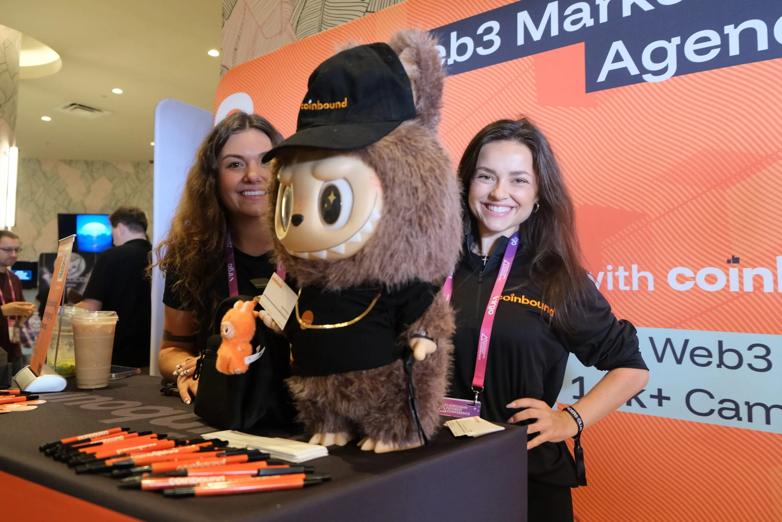 Alyssa Michaud, director of accounts at Coinbound (pictured left), brought her Labubu to the conference. Image: Decrypt/André Beganski